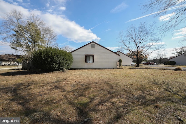 view of property exterior with a lawn