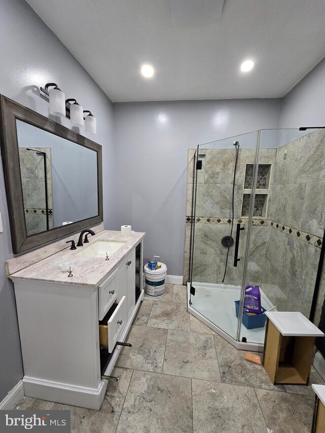 bathroom with vanity and a shower with shower door