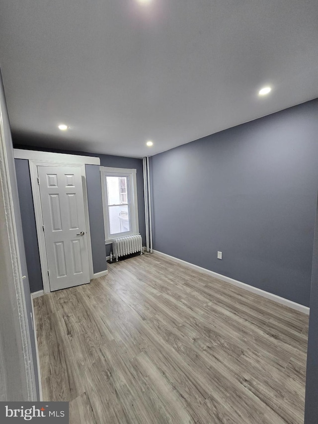 interior space featuring light hardwood / wood-style flooring and radiator heating unit