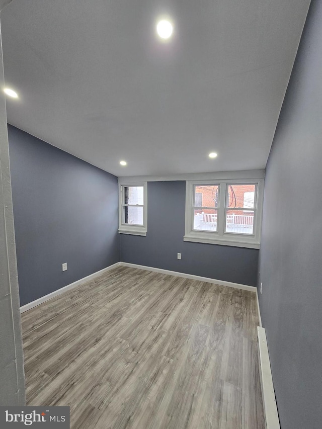 spare room with light hardwood / wood-style flooring and baseboard heating