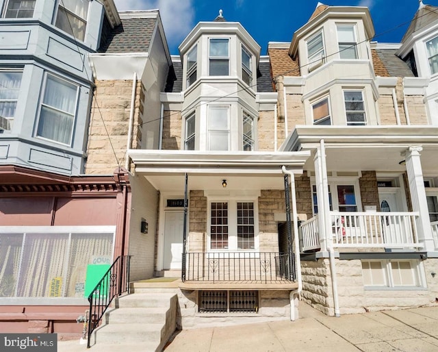 townhome / multi-family property with covered porch