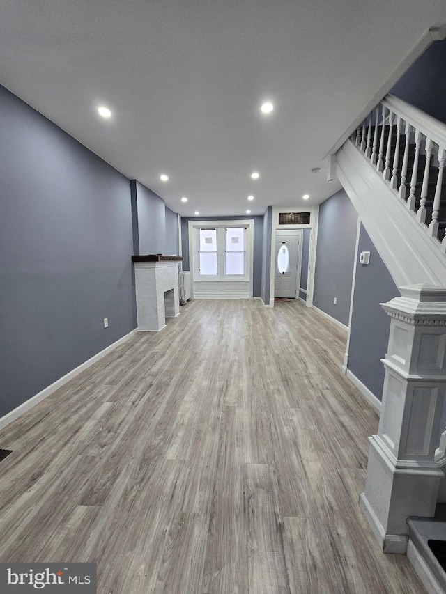 unfurnished living room with light hardwood / wood-style flooring