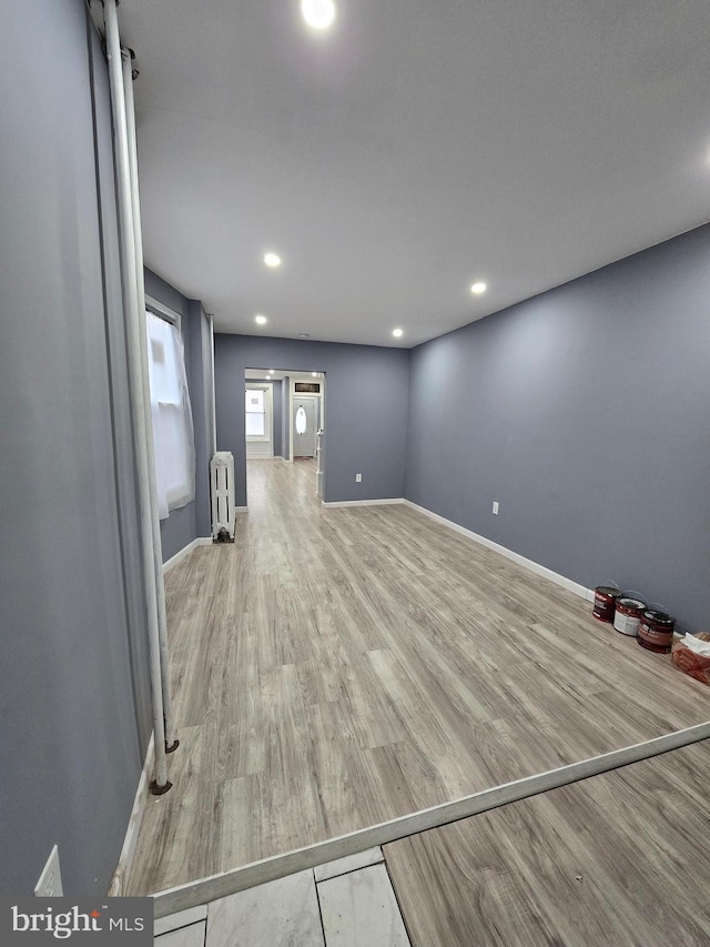 interior space with hardwood / wood-style flooring and radiator