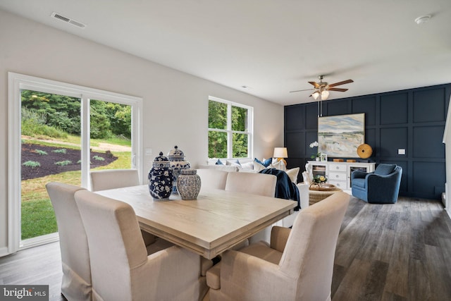 dining area with wood-type flooring and ceiling fan