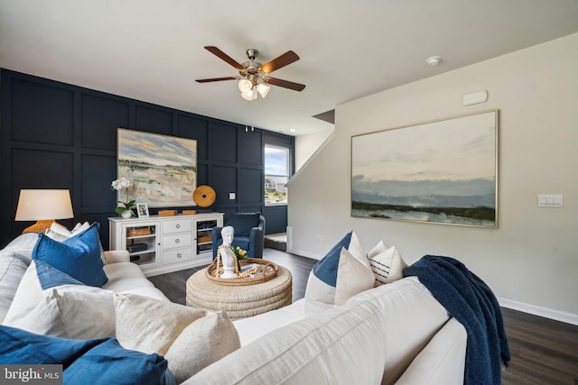 living room with dark hardwood / wood-style floors and ceiling fan