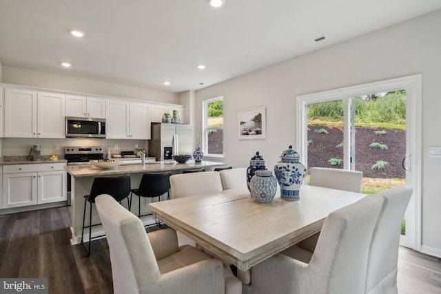 dining room with dark wood-type flooring and sink