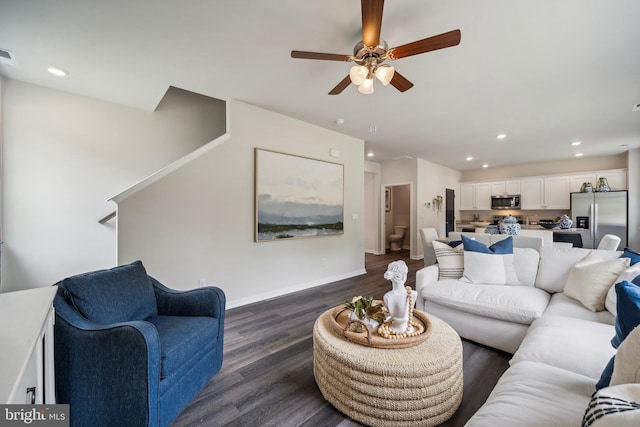 living room with dark hardwood / wood-style floors and ceiling fan