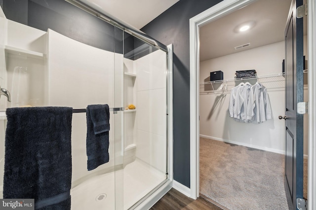 bathroom with a shower with shower door