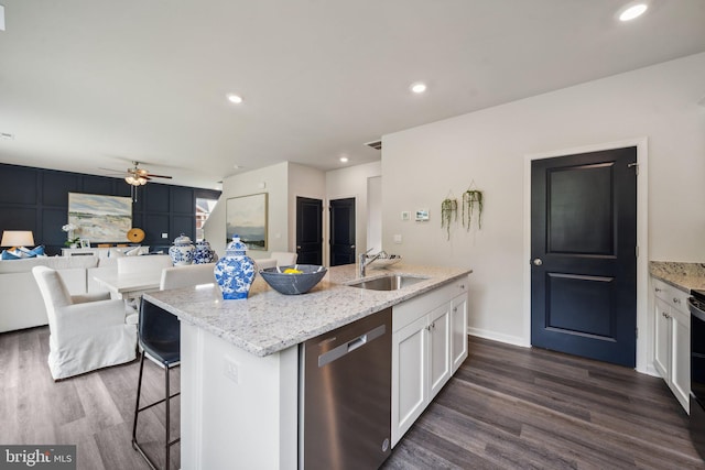 kitchen with white cabinetry, dishwasher, sink, an island with sink, and light stone countertops