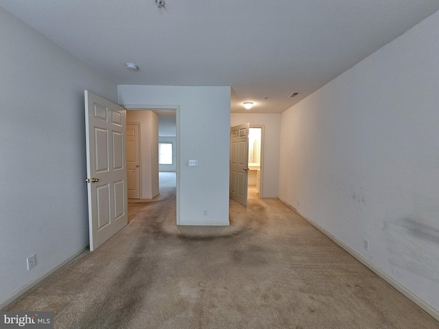 unfurnished room with light colored carpet