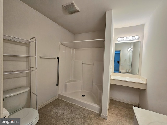 bathroom with a shower, vanity, and toilet