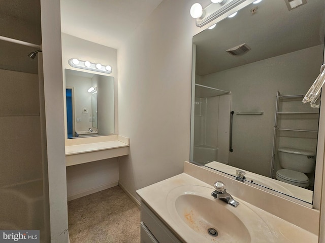 bathroom with toilet, vanity, and walk in shower