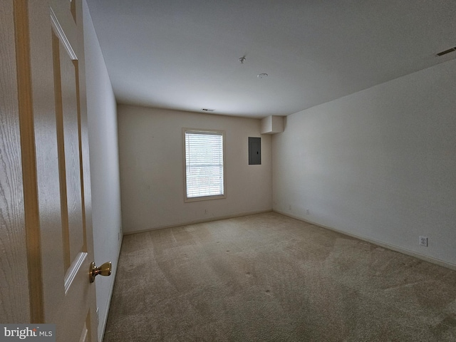 spare room featuring electric panel and carpet floors