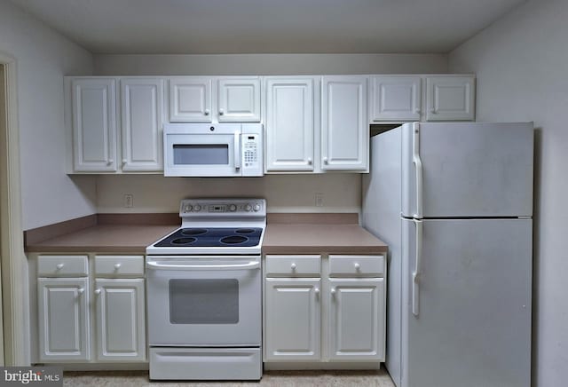 kitchen featuring white cabinetry and white appliances