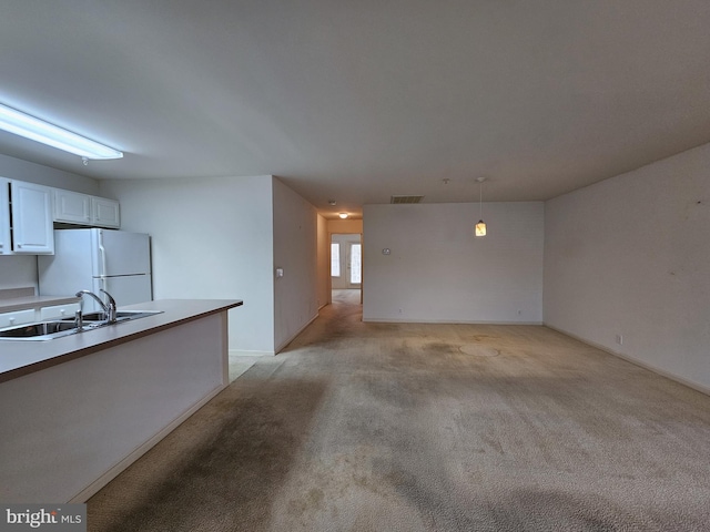 interior space featuring light colored carpet and sink