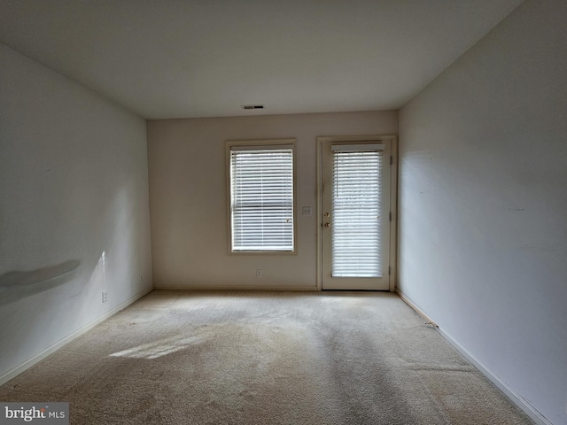 empty room with light colored carpet