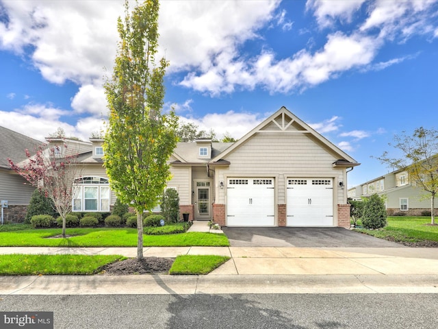 craftsman house featuring a garage and a front yard