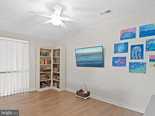 empty room featuring light hardwood / wood-style flooring, ceiling fan, and vaulted ceiling