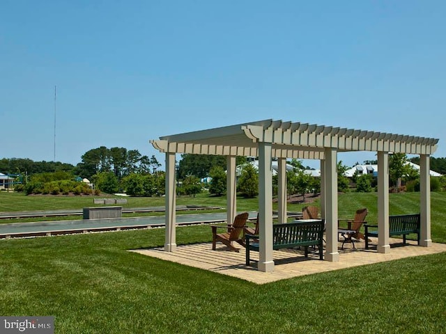 view of property's community with a yard and a pergola