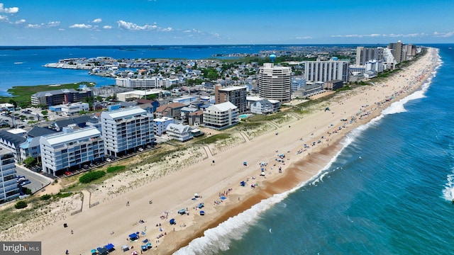 birds eye view of property featuring a beach view and a water view