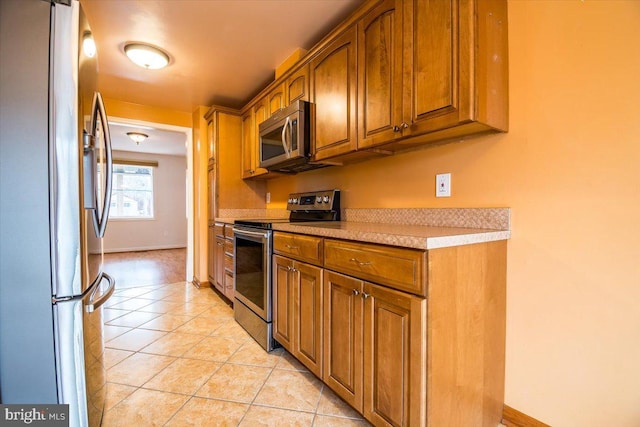 kitchen featuring light tile patterned floors and appliances with stainless steel finishes