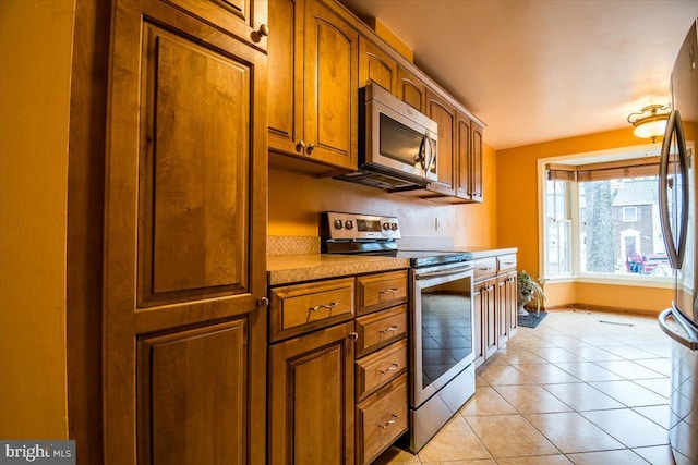 kitchen with stainless steel appliances and light tile patterned floors