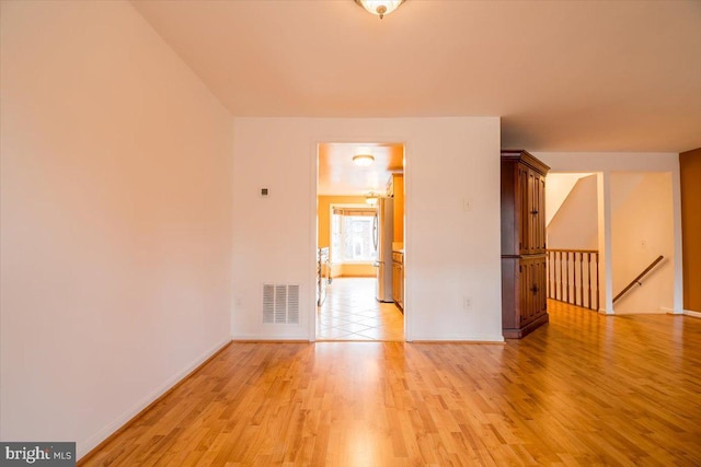 unfurnished room with light hardwood / wood-style flooring