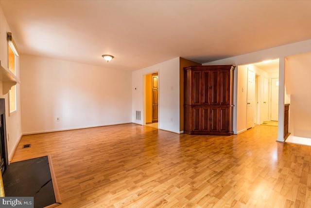 unfurnished living room with light hardwood / wood-style floors