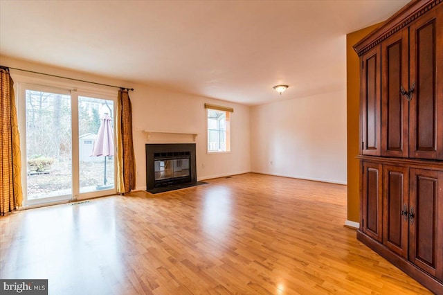 unfurnished living room with light wood-type flooring