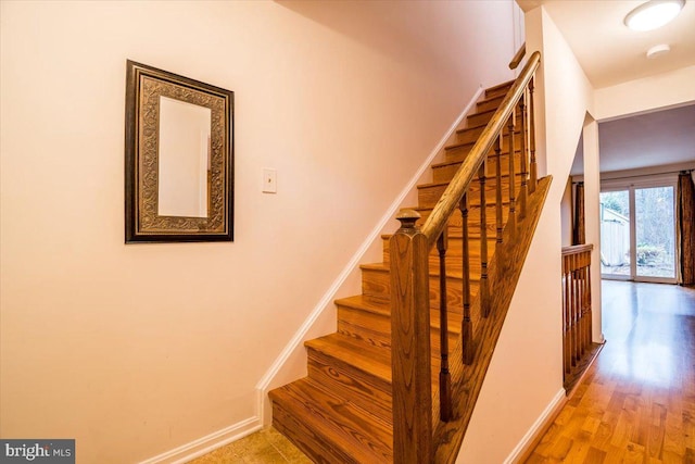 stairs with hardwood / wood-style floors