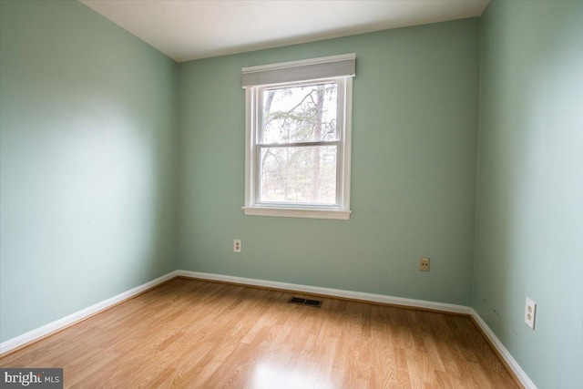 spare room featuring light wood-type flooring