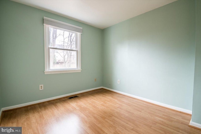 spare room with light wood-type flooring