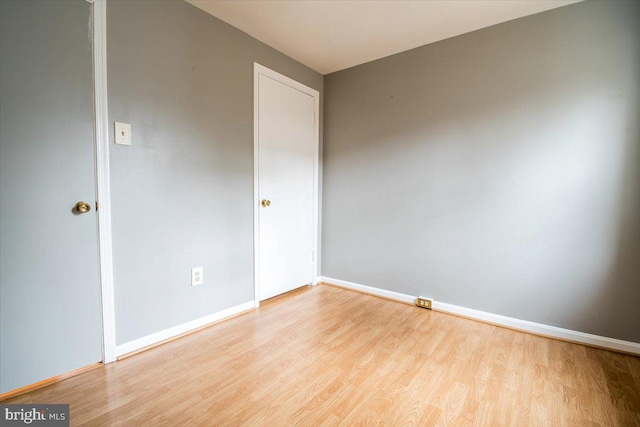 empty room with light hardwood / wood-style flooring