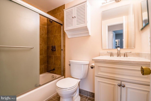 full bathroom with vanity, tile patterned floors, combined bath / shower with glass door, and toilet