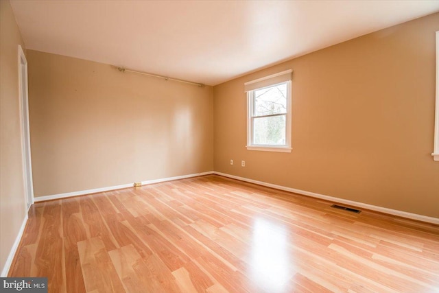 unfurnished room with light hardwood / wood-style floors