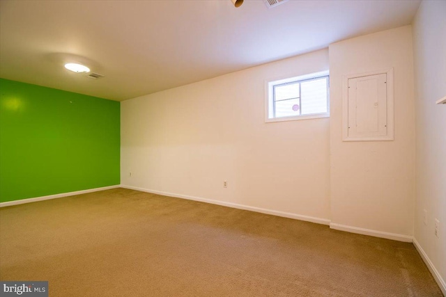 spare room featuring electric panel and carpet