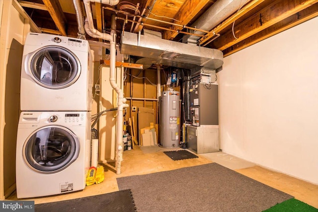 laundry area featuring water heater and stacked washer and clothes dryer