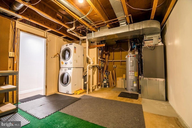 basement featuring stacked washing maching and dryer and water heater