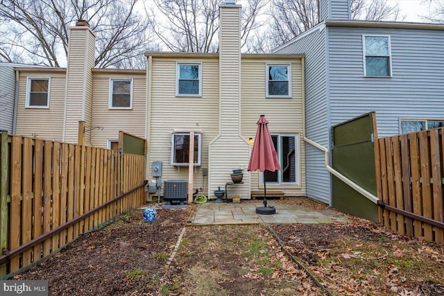 back of property featuring central AC unit and a patio