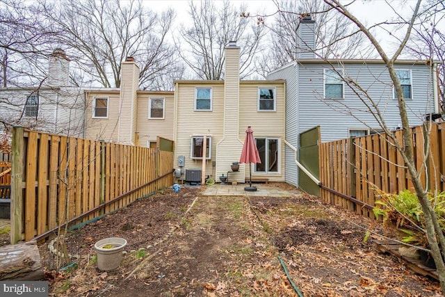 back of house featuring central AC unit and a patio area