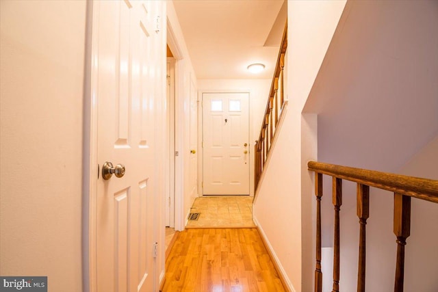 hallway with light hardwood / wood-style flooring