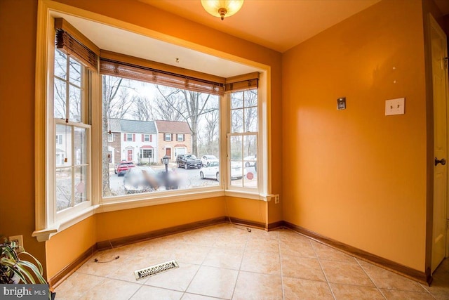 unfurnished dining area with light tile patterned flooring