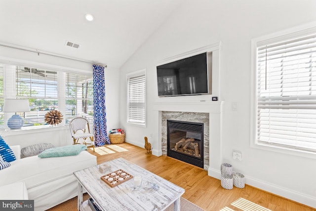 living room with vaulted ceiling and hardwood / wood-style floors