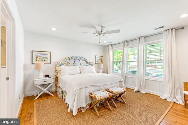 bedroom with ceiling fan and hardwood / wood-style floors