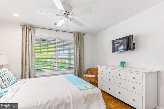 bedroom with ceiling fan and light hardwood / wood-style flooring