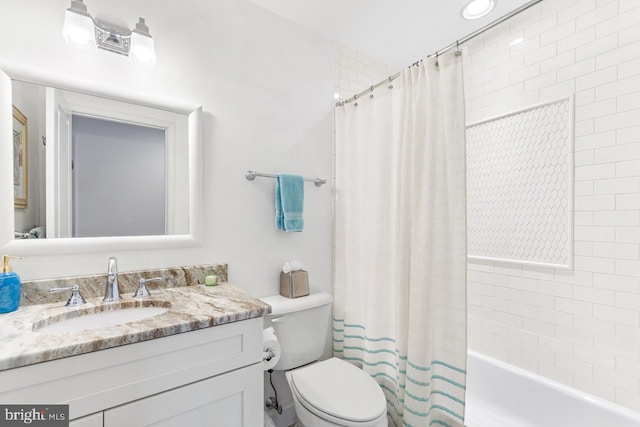 full bathroom with vanity, toilet, and shower / tub combo