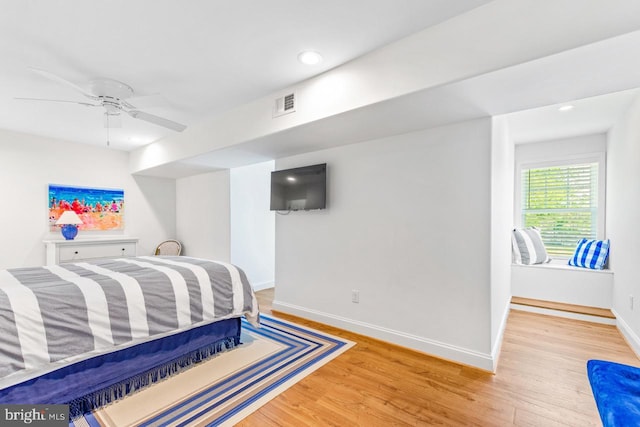 bedroom with light hardwood / wood-style flooring and ceiling fan