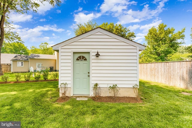 view of outbuilding with a yard