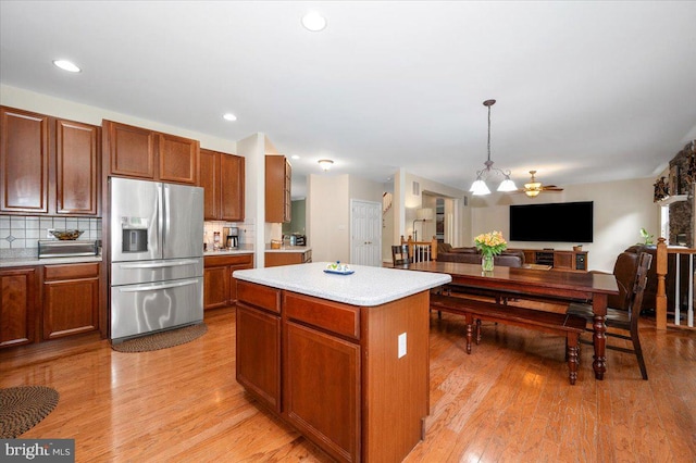 11050 Sanandrew Dr, New Market, MD 21774 - kitchen with stainless steel fridge, light countertops, open floor plan, backsplash, and recessed lighting