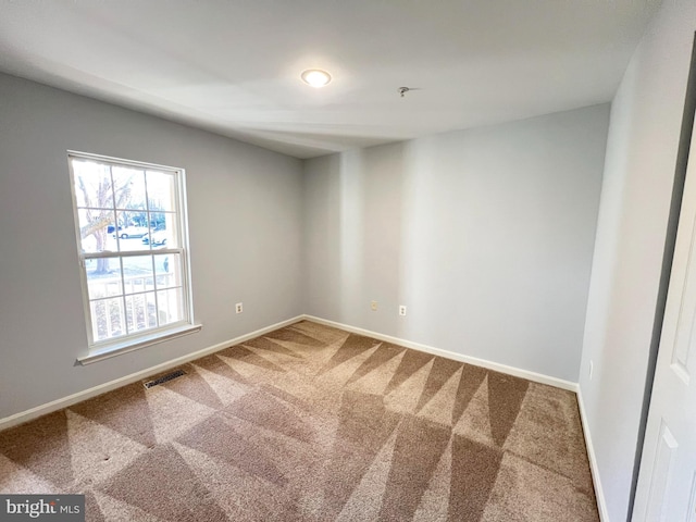 unfurnished room featuring carpet